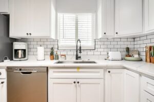 Bright, modern kitchen with white cabinetry and subway tile backsplash.