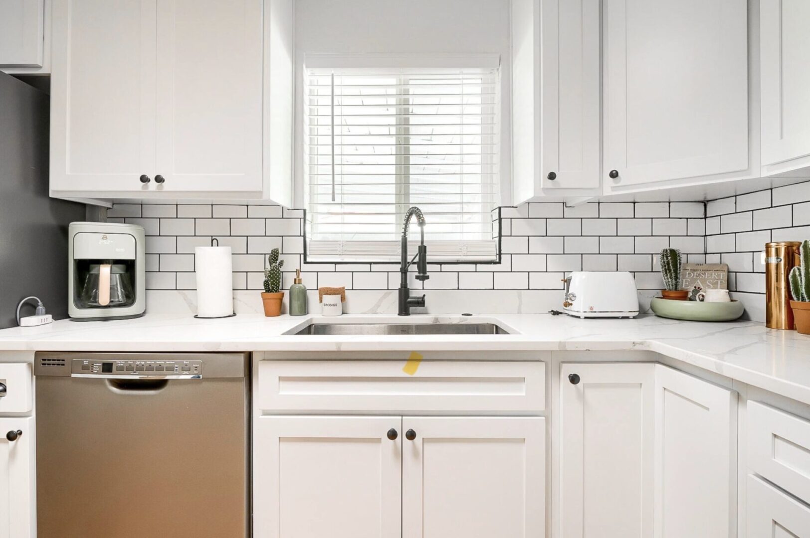 Bright, modern kitchen with white cabinetry and subway tile backsplash.