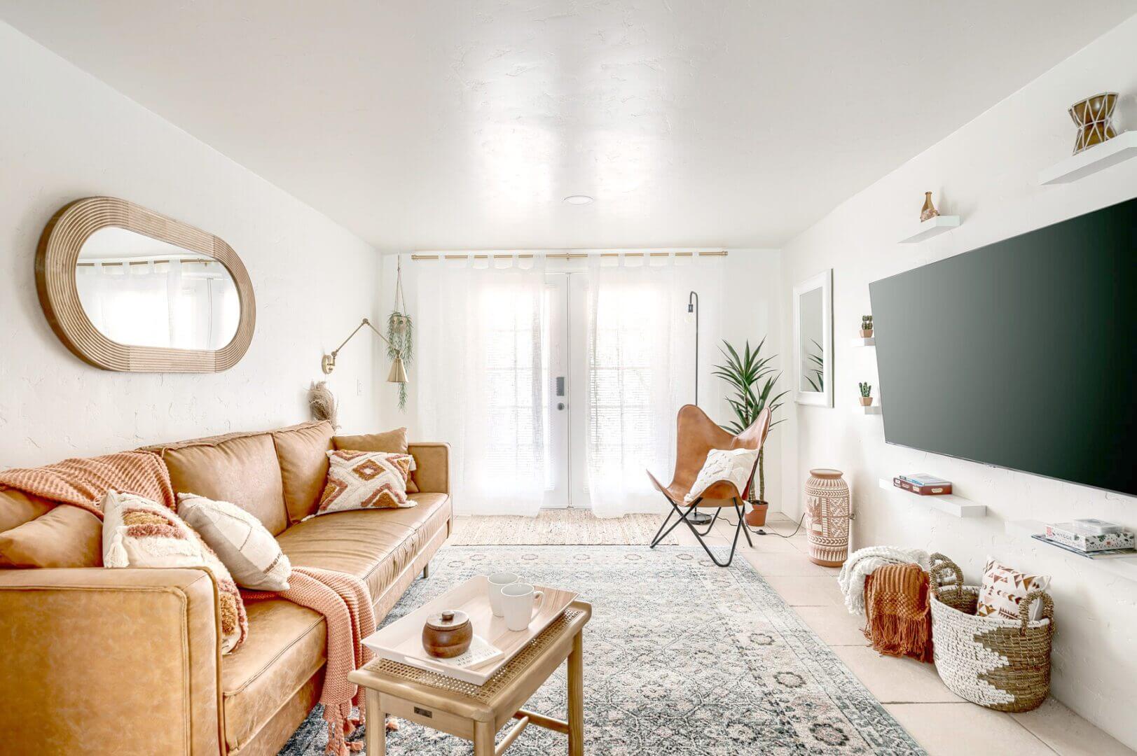 Bright, cozy living room with natural light, neutral tones, and comfortable seating.