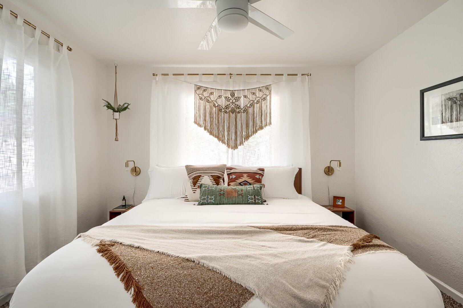 Cozy bedroom with boho-chic décor and natural light.