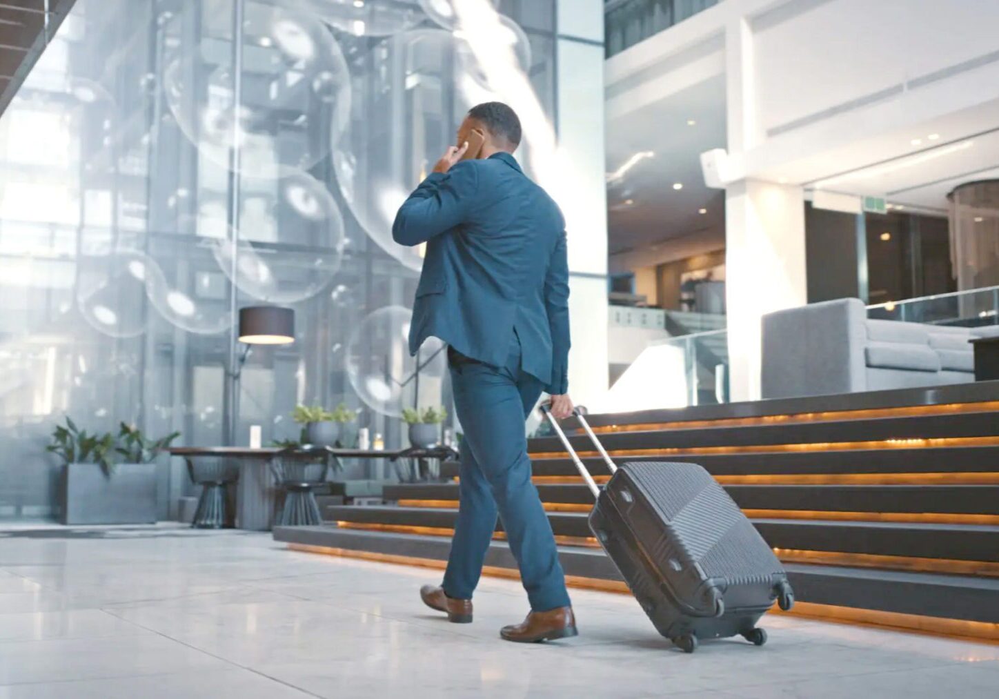 Business traveler walking through sleek hotel lobby