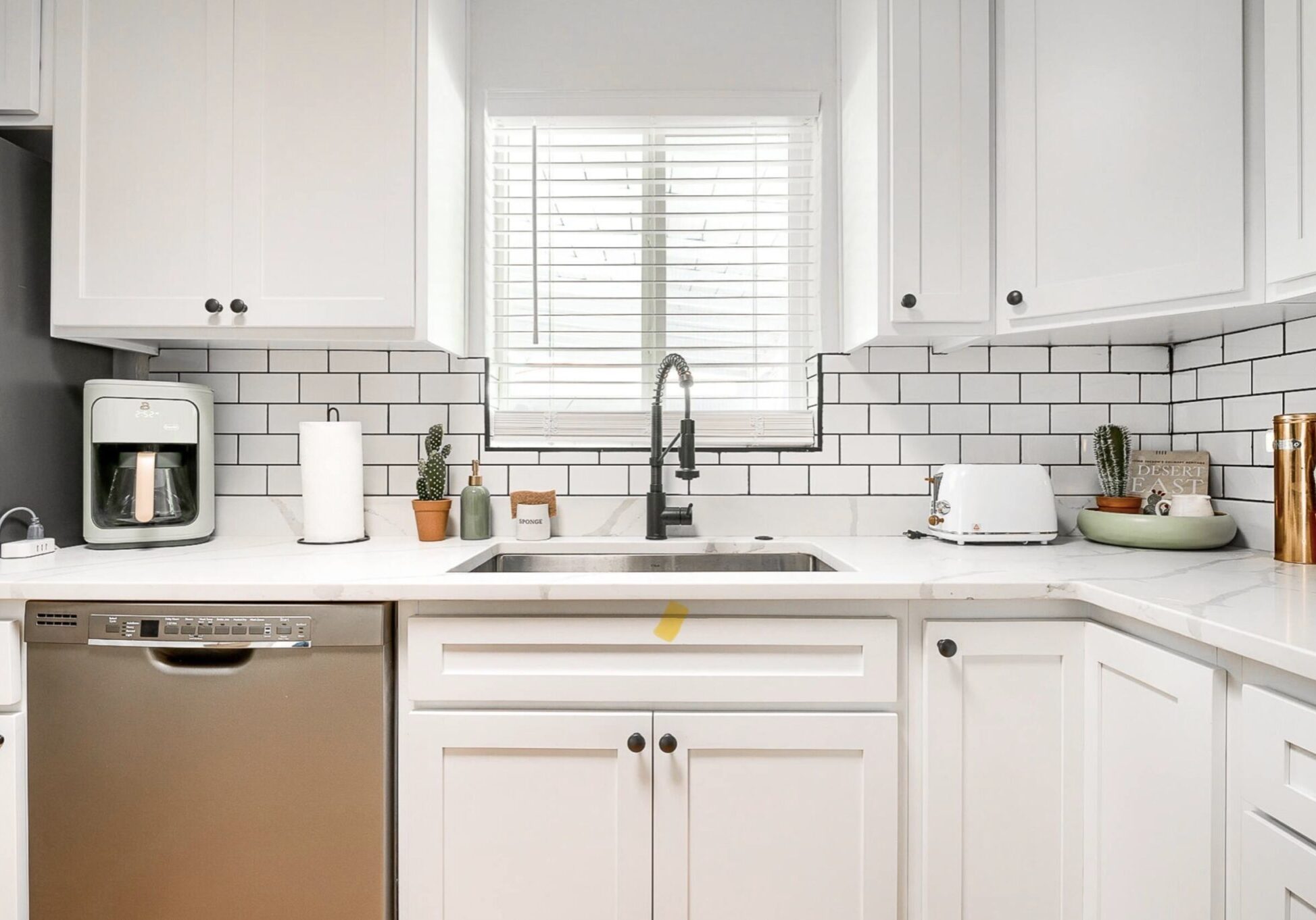 Bright, modern kitchen with white cabinetry and subway tile backsplash.
